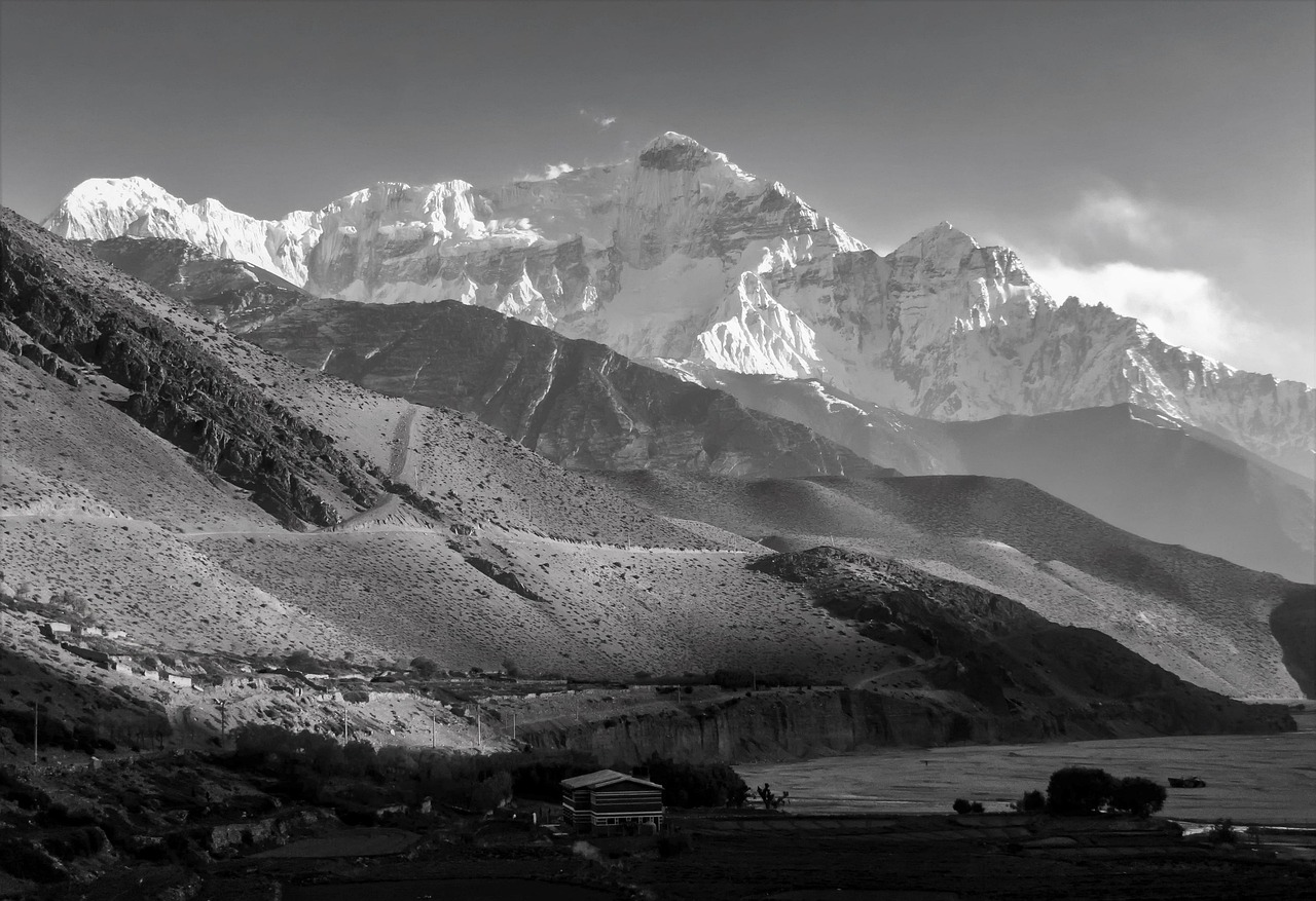 Trekker on a high Himalayan pass with panoramic views